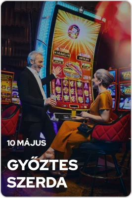 Egy elegánsan öltözött pár, aki egy fényárban úszó kaszinó szórakoztató részlegében egy játékgéppel játszik
